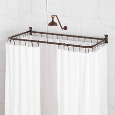 a white shower curtain with an old - fashioned faucet hanging from it's side