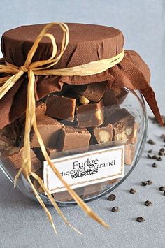 a glass jar filled with chocolate pieces on top of a table