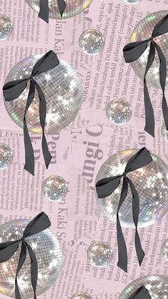 disco balls with black ribbons on a pink background seamless wallpaper, suitable to use as wrapping paper or fabric