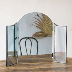 a mirror sitting on top of a wooden table