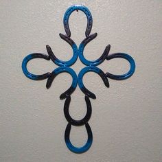 a blue metal cross hanging on the wall