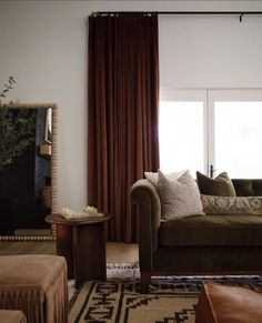 a living room filled with furniture and a large window