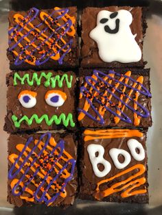 four halloween brownies decorated with icing and sprinkles