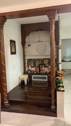 the inside of a home with wooden floors and pillars