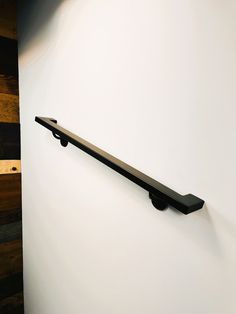 a metal shelf mounted to the side of a wall