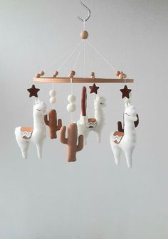 a mobile with llamas and stars hanging from it