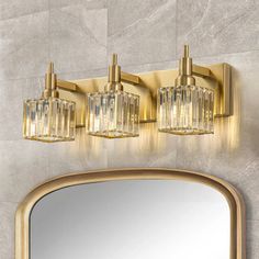 a bathroom vanity with a mirror and lights on the wall next to an oval shaped light fixture