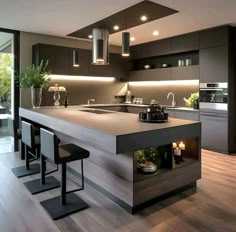 a modern kitchen with an island in the middle and candles on the counter top next to it