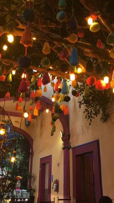 the ceiling is decorated with colorful lights and tassels hanging from it's rafters