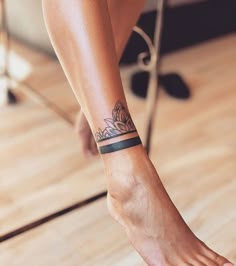 a woman's foot with a tattoo on her left arm and the bottom part of her leg