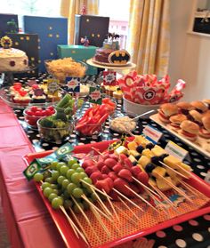 a table topped with lots of food and desserts