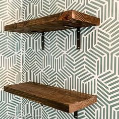 two wooden shelves against a patterned wall