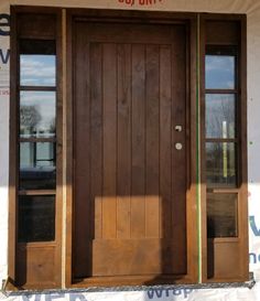 the front door of a building with two windows