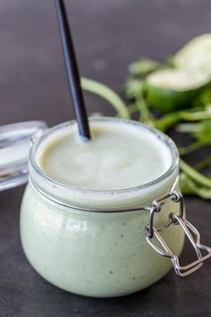 a glass jar filled with liquid sitting on top of a table