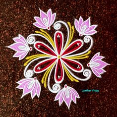 an intricate flower design is painted on the ground in pink, yellow and white colors