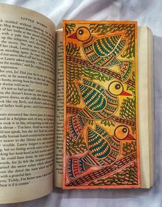 an open book with colorful designs on it