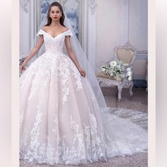 a woman in a wedding dress is posing for the camera with her hands on her hips