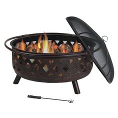 an outdoor fire pit is shown with the lid open and flames coming out from it