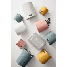 several different colored rolls of toilet paper next to each other on a white surface,