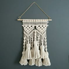 a white macrame hanging on a wall