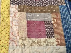 an old patchwork quilt with many different colors and patterns on it's edges