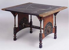 an old wooden table with marble top and ornate carvings on the sides, sitting against a white background