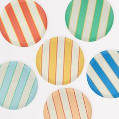 four plates with different colored stripes on them