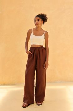 The elastic waist flowy trousers offer comfort with a graceful, effortless style. Handcrafted in our studio to your measurements and preferences, available in over 60 colors. STYLE DETAILS - 100 % linen, medium weight (200gsm), free-shrinkage, amazingly soft feel - Floor length pants; different length is possible - High waisted - Wide-legs - Elastic waistband - Inseam pockets - Pants inseam 29''/73cm and pants outseam 39''/98cm/size S for our lovely model 5ft5/169cm tall. - Leg opening width of Versatile Linen Wide Leg Beach Pants, Solid Color Linen Wide Leg Pants With Elastic Waistband, Solid Color Linen Wide Leg Harem Pants, Effortless Wide-leg Summer Pants, Ankle-length Linen Harem Pants For Vacation, Brown Linen Wide Leg Bottoms, Linen Wide Leg Pants With Elastic Waistband, Effortless Summer Wide Leg Pants With Elastic Waistband, Brown Wide Leg Linen Bottoms