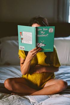 a woman sitting on a bed reading a book with the caption'are you my mother? '