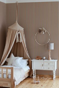 a bedroom with striped walls and wooden floors