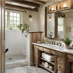 a bathroom with double sinks and wooden cabinets