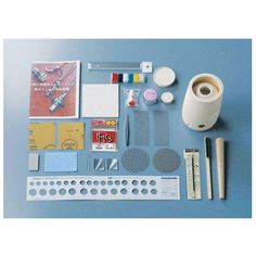 the contents of a craft kit laid out on a blue surface