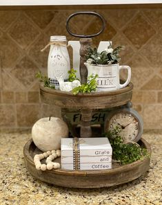 three tiered tray with books, coffee mugs and other items