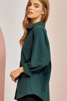 A cozy oversized tunic top for relaxed yet chic style. This magenta button-down shirt features a subtle button sleeve tack detail, patch front pockets, and an easy, roomy fit perfect for easy days wear. Throw it on with jeans and flats for effortlessly cool comfort. ***Color is closer to a Dark Teal, than the name Hunter Green*** 95% Polyester 5% Spandex Want to view this on the *Live* Sizing & Styling Guide?! Watch it in the photo section above or click here! *You will need to scan through to f Oversized Solid Color Collared Blouse, Oversized Collared Solid Color Blouse, Fall Shirt With Rolled Sleeves For Day Out, Trendy Oversized Solid Color Blouse, Oversized Blouse With Roll-up Sleeves And Shirttail Hem, Oversized Long Sleeve Solid Color Shirt, Oversized Solid Color Blouse For Day Out, Solid Color Shirt For Fall Day Out, Fall Shirt For Day Out