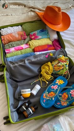 an open suitcase filled with clothing and accessories