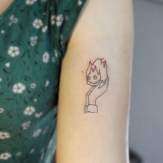 a woman with a small tattoo on her arm