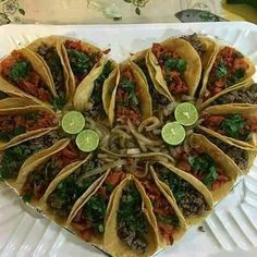 a heart shaped tortilla with toppings on it