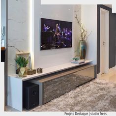 a living room filled with furniture and a flat screen tv mounted to the side of a wall