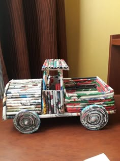 a toy truck made out of magazines sitting on top of a table