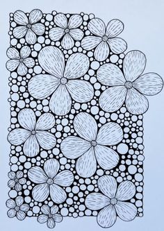 a black and white drawing of flowers on a sheet of paper with dots in the middle