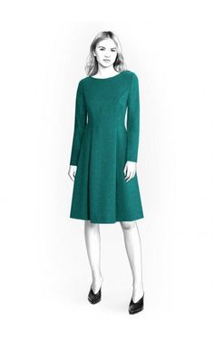 a woman is wearing a green dress and black shoes