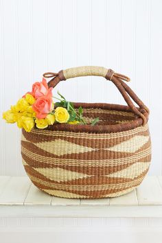 a basket with flowers in it sitting on a table