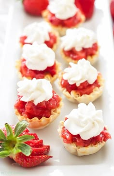 strawberry shortcakes with whipped cream and fresh strawberries on the side, ready to be eaten