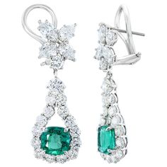 A beautiful and chic pair of drop earrings showcasing a cluster of brilliant mixed-cut diamonds, and cushion-cut emeralds set in an intricate and stylish design. 8 Mixed cut Diamonds weigh 1.62 carats in total. 2 vivid green emeralds weigh 4.62 carats in total. Made in 18k white gold. 32 accent diamonds weigh 4.11 carats in total. The color of these gemstones is ideal, with great luster/shine. Omega clasp with a post. Diamond Drops, Diamond Drop Earrings, Emerald Diamond, Cushion Cut, Diamond Jewelry, Diamond Earrings, Diamond Cuts, Vintage Jewelry, Emerald