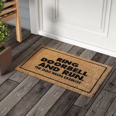 a door mat that says ring dobble and run on the floor next to a potted plant