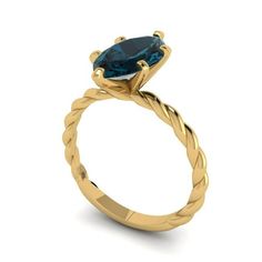 a yellow gold engagement ring with an oval blue topazte stone in the center