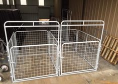 two white metal cages sitting next to each other