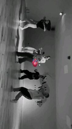 three people standing in a room with one holding a frisbee