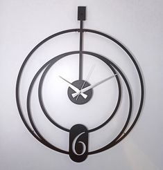 a clock that is on the side of a wall with circles and numbers around it