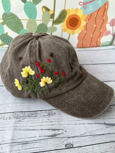 a brown hat with flowers embroidered on it